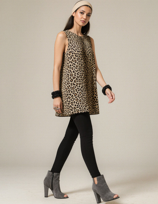 "A high-resolution Photo of a SaudiArabia woman.She wears a sleeveless, loose-fitting mini dress with a leopard print. The pattern is in natural tones (brown, beige, black) and is very striking, almost clichÃ©dly sexy. She pairs it with a black, tight-fitting leggings that completely cover her legs and give the look a touch of everyday wearability. She wears gray, open-toe high-heeled ankle boots with a cut-out for the toes â fashionable, but not overly glamorous. A wide, light-colored hairband holds back her hair with a center parting. The hairband gives her a somewhat youthful, almost naive look. She wears large black bracelets on both wrists, which serve as a fashion statement. She wears eye-catching rings on her left hand. Her makeup is rather subtle, with a focus on the lips and eyes â which fits well with her psychologically <lora:SaudiArabia:1>"