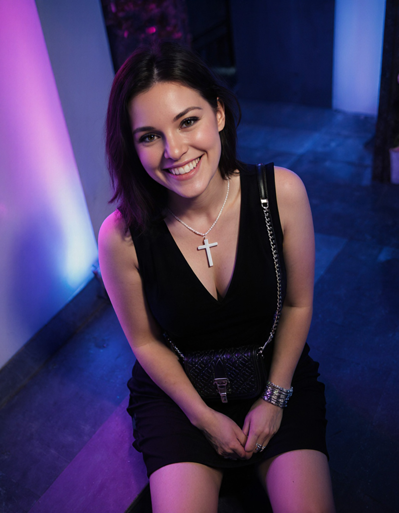 "photography of a smiling Canada woman, dressed in black dress, sleeveless top, plunging neckline, white cross necklace, textured handbag, silver bracelet, sitting down, legs bent, hands on knee, relaxed demeanor, Cool color palette, neon lights, (top down:1.4), shot on Nikon Coolpix P950 with Built-in 24-2000mm f-2.8-6.5 <lora:Canada:1>"