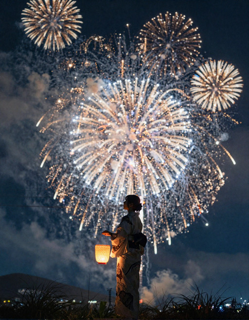 A cinematic night scene capturing a young woman in traditional Japanese attire standing in a field, watching a spectacular fireworks display in the sky. The composition is backlit, rendering the woman mostly in silhouette while emphasizing the brilliant explosions behind her.

The woman stands slightly off-center, holding a small glowing lantern in one hand. The lantern emits a soft warm yellow light, illuminating part of her hand and sleeve. She wears a traditional yukata with subtle patterns, and her hair is styled neatly, possibly tied back or in a simple traditional arrangement.

Her posture is calm and upright, facing the fireworks, with her head slightly tilted upward. Her silhouette is elegant and clearly defined against the bright bursts of light.

The background sky is filled with multiple layers of fireworks exploding in different sizes and stages. Large central bursts radiate outward in symmetrical patterns, with fine streaks of light extending like spokes. Smaller fireworks bloom around them, creating depth and layering. Trails of sparks arc downward, leaving glowing paths.

The foreground includes silhouettes of grass and plants, adding depth and framing. Thin utility wires may faintly cross the scene, adding a subtle urban touch without distraction.

Lighting is dramatic and high contrast: bright, colorful fireworks (gold, white, orange, hints of blue) against a deep dark blue night sky. The lantern adds a secondary warm light source, balancing the composition.

The color palette is rich and vibrant, with strong warm highlights from fireworks contrasted against cool dark tones. The scene feels festive, nostalgic, and cinematic.pure immersive visual storytelling.

Shot with a telephoto lens, shallow depth of field, long exposure feel for fireworks trails, ultra-detailed sparks, cinematic lighting, high contrast, HDR rendering, film still aesthetic, ultra high resolution.