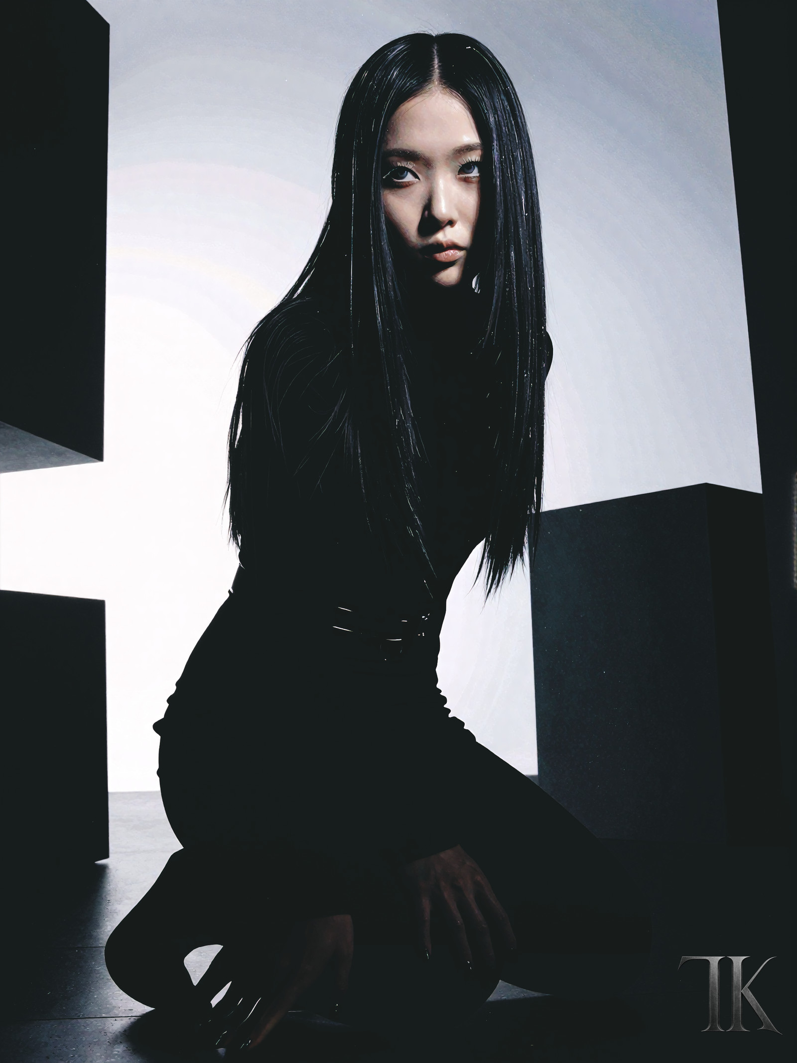 A cinematic high-fashion editorial shot captured in a subtle low-angle perspective, the camera positioned just below eye level to create a gentle upward tilt that amplifies the poised female figureâs refined power and modern monolithic minimalism, her heart-shaped face with high cheekbones, narrow jaw, and almond eyes framed by heavy lashes and icy gray eyes with soft under-eye shadowing and a bruised romantic look, her ultra-sleek straight black hair precisely centered and falling in perfectly aligned strands with minimal volume and subtle natural shine, her very fair porcelain-like skin with cool undertones accentuated by a slim tonal belt merging seamlessly into her silhouette, all while she kneels with a structured spine and lowered chin in a minimalist column dress of dense matte black fabric, the directional backlight carving angular silhouettes against the void space defined by sharp rectangular light cuts and a floating black geometric block near the frameâs edge, the atmosphere thick with monolithic psychological weight bordering abstraction, her calm observational gaze and relaxed facial tension modulating presence with high sensuality and low horror intensity, the scene bathed in disciplined low-key exposure with controlled depth of field and volumetric lighting that highlights the layered black tonal separation between matte, satin, and structured fabrics, the architectural black fashion portrait framed by massive geometric void structures that echo the Modern monolithic minimalism of her outfit, the void space suffused with restrained specular reflections and sharp negative space, the composition balanced by the interplay of directional highlights and the subtle metallic micro-detail of TK barely visible in shadow, all rendered in 4k ultra-detailed absurdres with best quality, amazing aesthetic, and newest scenic depth, the East Asian (Japanese/Korean) modelâs short natural nails in matte black completing the ensemble, her expression a blend of severe editorial composure and intimate proximity shaped by darkness and form, the entire scene a masterpiece of architectural void fashion portraiture where black becomes spatial structure and geometric form, the horror intensity modulated to a whisper beneath the surface of monolithic stillness.